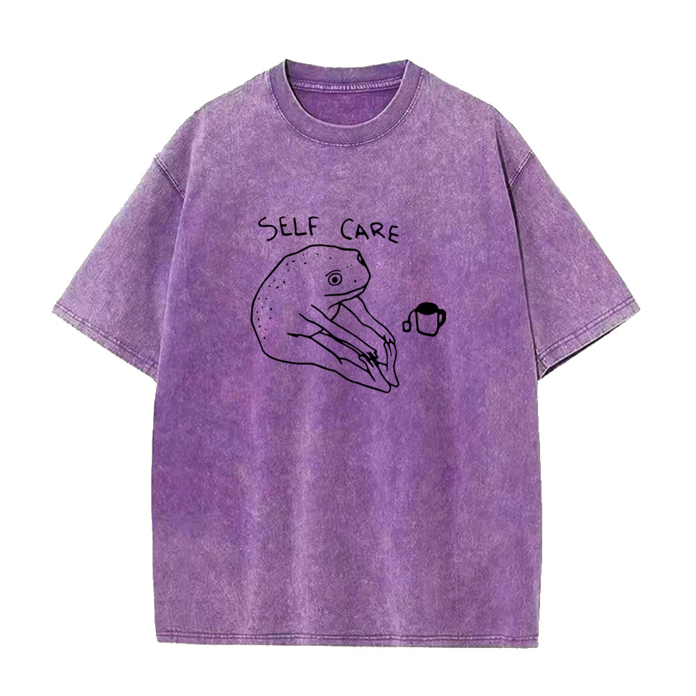 Purple t-shirt with 'self care' design on a white background