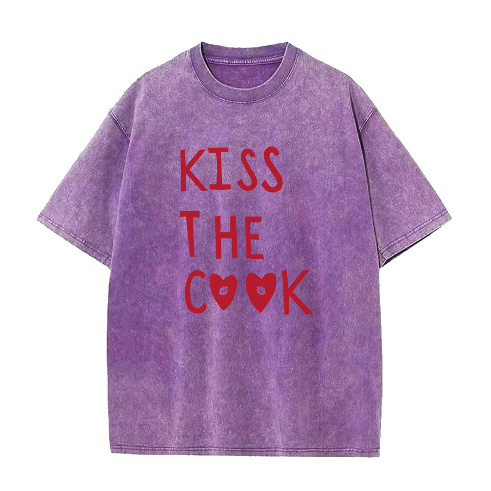 Purple t-shirt with red text 'KISS THE COOK' on a white background