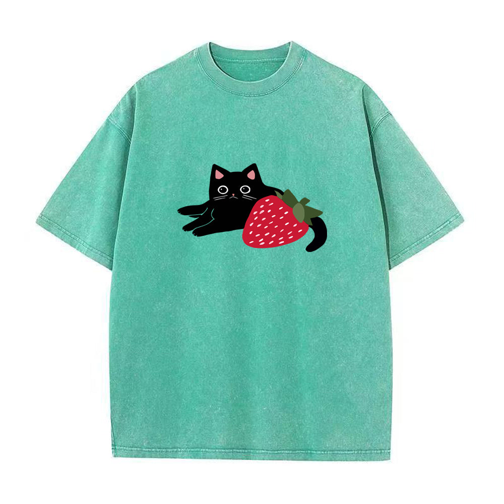 Green t-shirt with a black cat and strawberry design on a white background