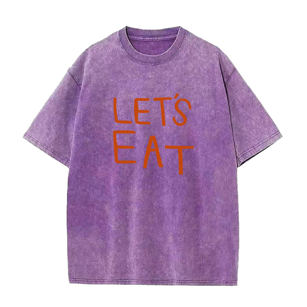 Purple t-shirt with 'LET'S EAT' text in orange on a white background