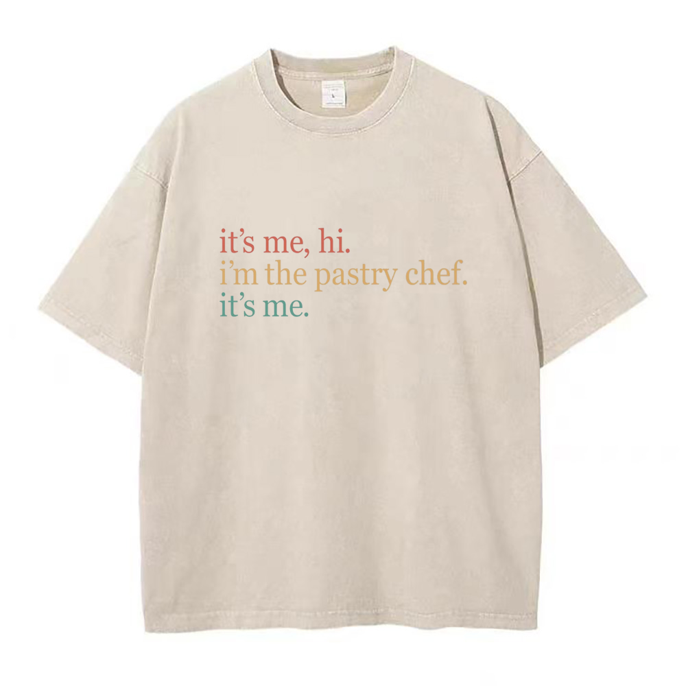 Oversized beige crew neck t-shirt with text 'it's me, hi. i'm the pastry chef.