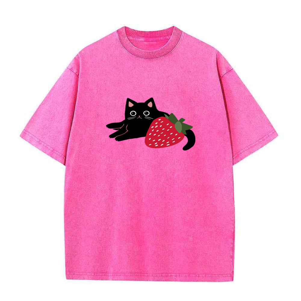 Pink t-shirt with a black cat and strawberry graphic on a white background