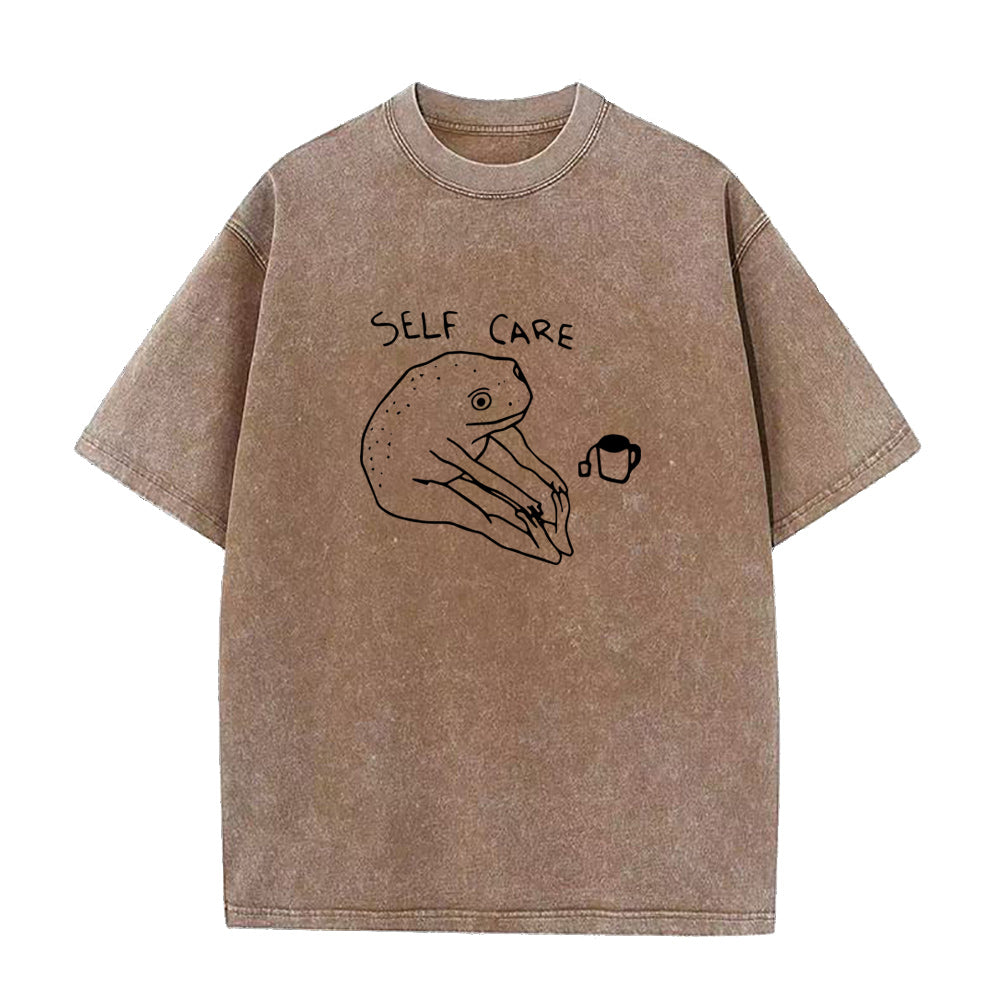 Brown t-shirt with 'self care' and hand-drawn graphic on a white background