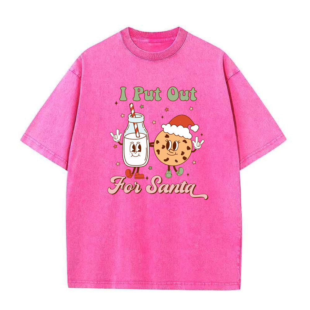 Pink t-shirt with cartoon character and text 'I Put Out For Santa' on a white background