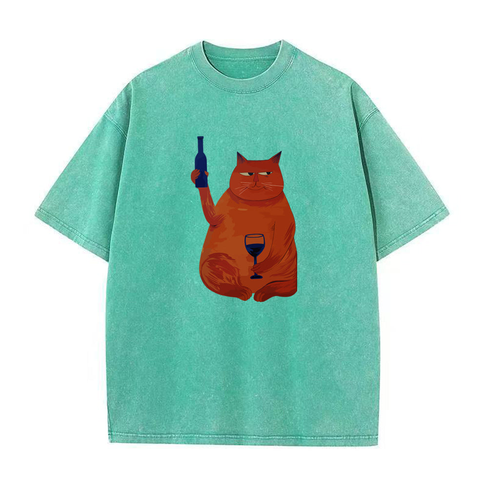 Green t-shirt with a graphic of a cat holding a bottle and glass on a white background