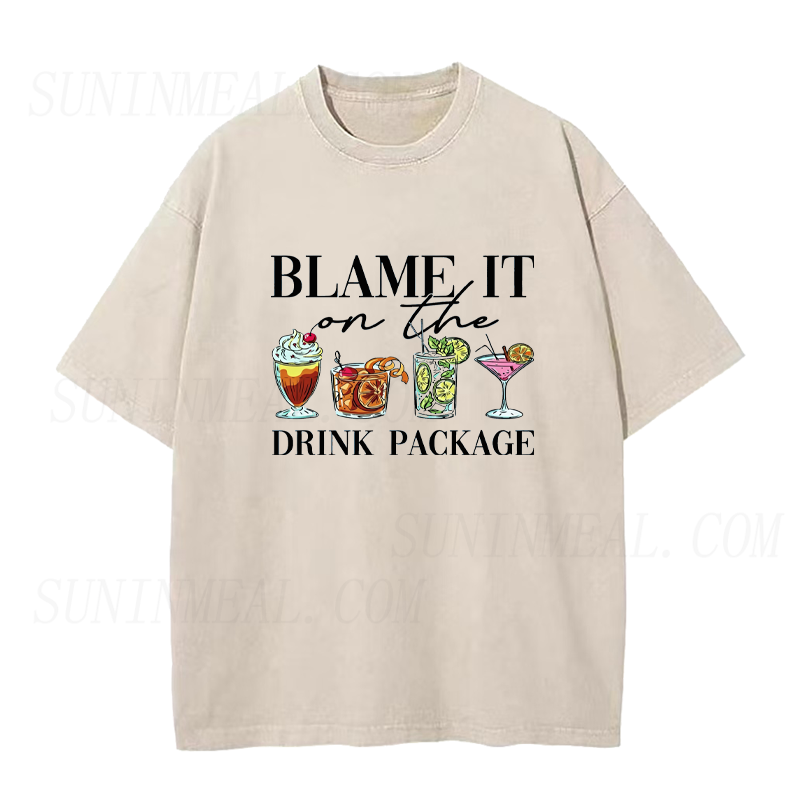 Beige t-shirt with cocktail graphic and text 'Blame it on the drink package' on a white background